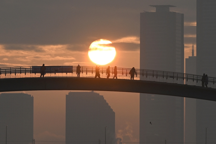 The sun rises over high-rises in downtown Seoul